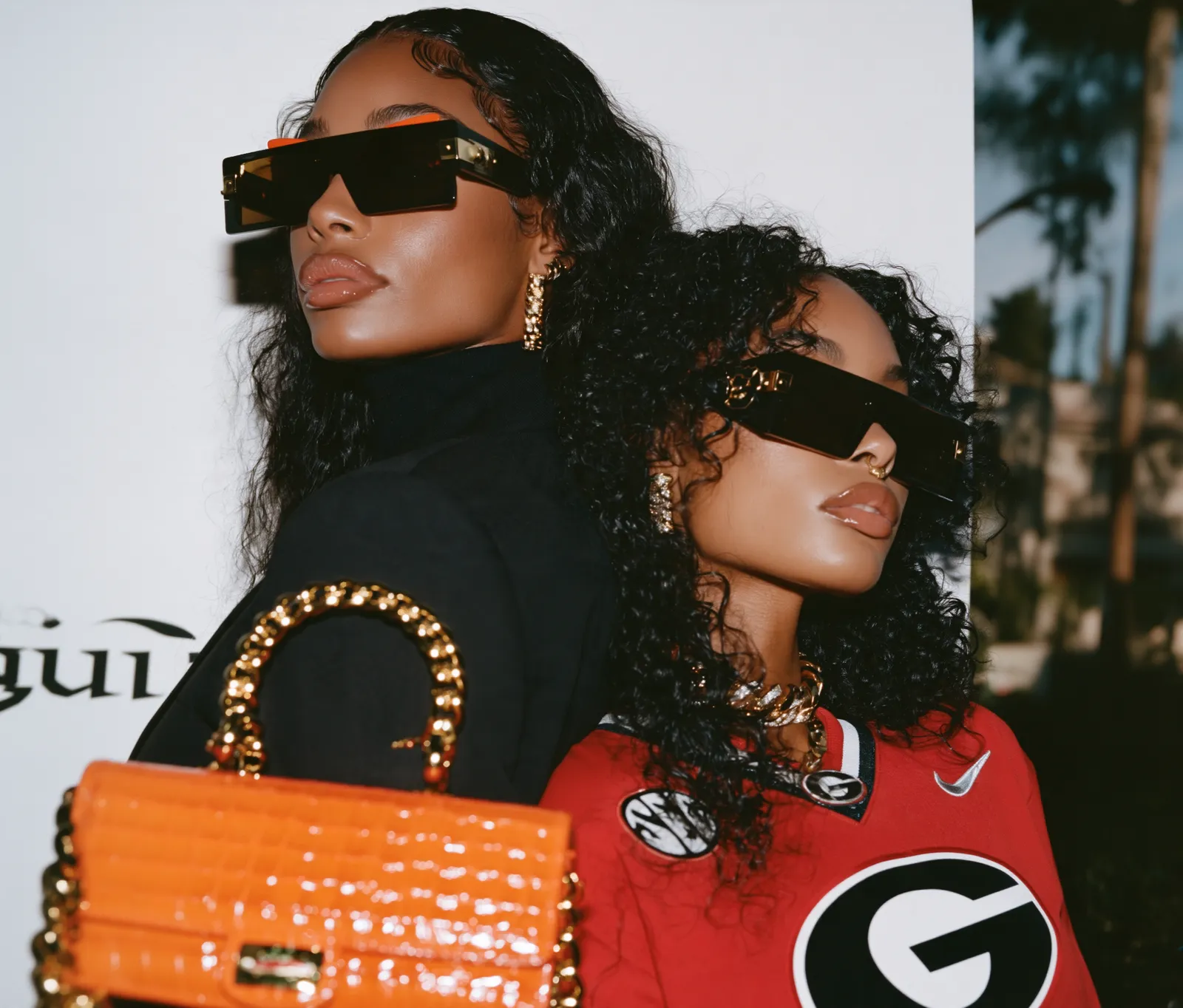 Two women in sunglasses, one in a Georgia jersey